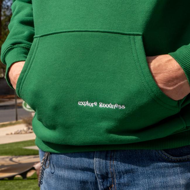 A green boathouse heavyweight sweatshirt with the Dogfish Head logo embroidered in black on the front and the slogan 