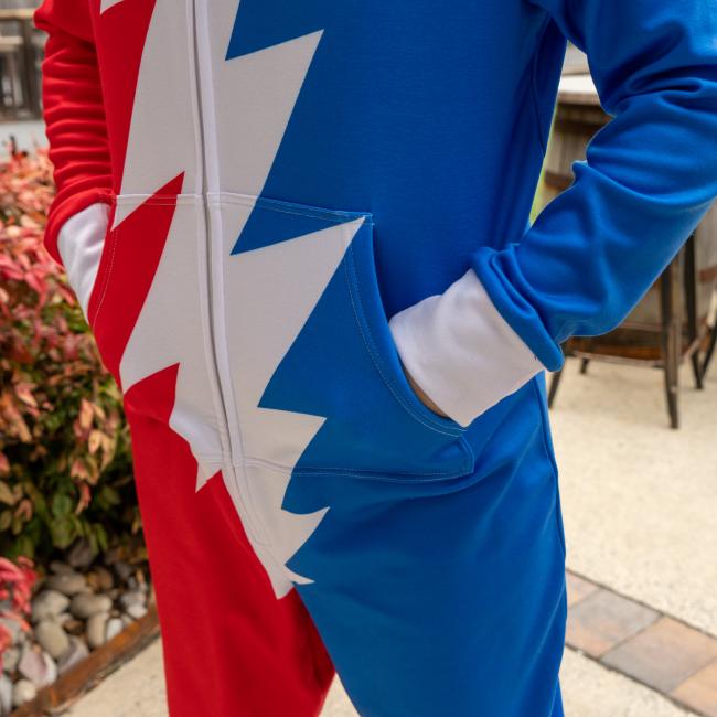 Close up of kangaroo pocket adult hooded unisex onesie. Red and blue with white grateful dead lightening bolt. 