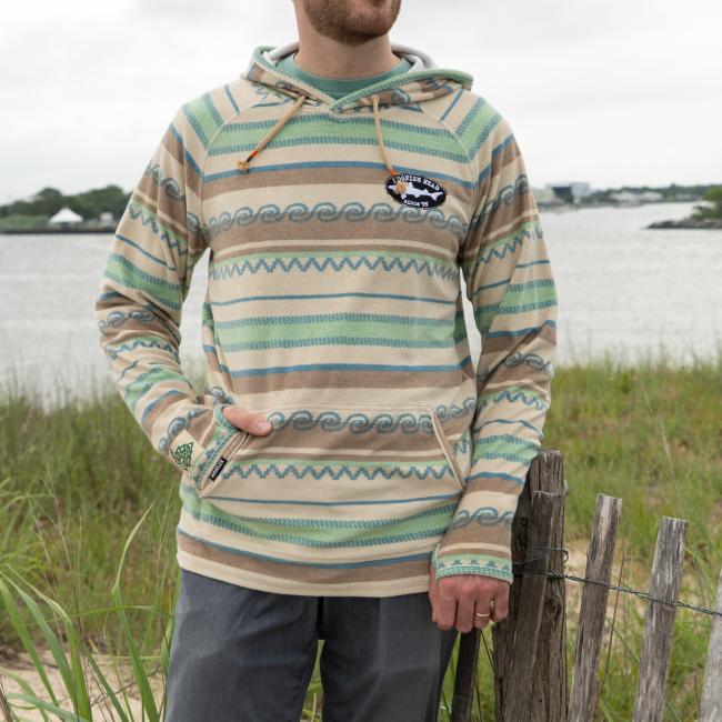 Male model wearing Howler multi stripe terry cloth stripe hoodie with small Dogfish Head shark & shield embroidered logo on left chest area. 