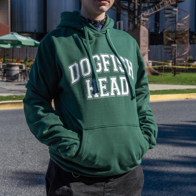 Dogfish Head Collegiate Hoodie in Green with White Dogfish Head Lettering on The Front Worn By a Model