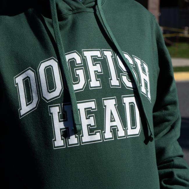 Dogfish Head Collegiate Hoodie in Green with White Dogfish Head Lettering in White on The Front Up Close View Worn By a Model