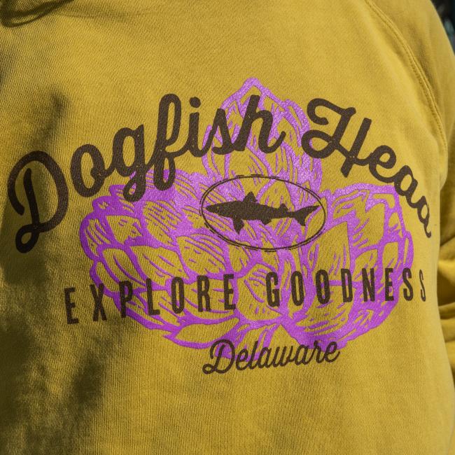 Dogfish Head Yellow Ashlyn Crew Sweatshirt with Purple Hop Graphic on the Front The with Explore Goodness in Brown Written in the Middle
