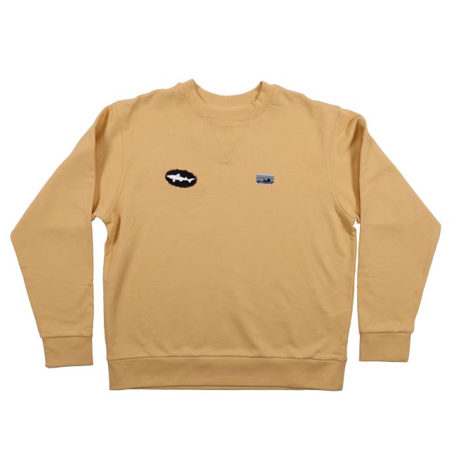 Front view of a yellow Patagonia crewneck sweatshirt featuring two chest patches—one with the Dogfish Head white shark logo on a black oval, and the other with the classic Patagonia mountain logo in blue, red, and black.