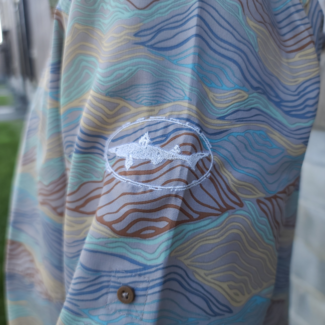 Dogfish Head and Patagonia Tan Mountain Button Up Side View of Dogfish Head Shark Logo On Sleeve