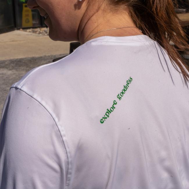 A white UPF long sleeve tee with the slogan 