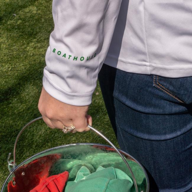 A white UPF long sleeve tee with the Boathouse logo on the left wrist  in green.