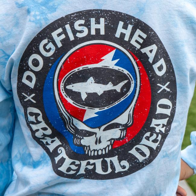 Close-up of the back graphic on the shirt featuring a distressed circular design with the Dogfish Head shark inside a skull and lightning bolt motif.