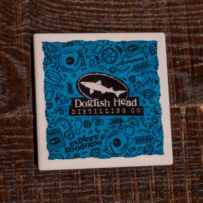 Front of coaster featuring shark logo and Dogfish Head Distilling Co.