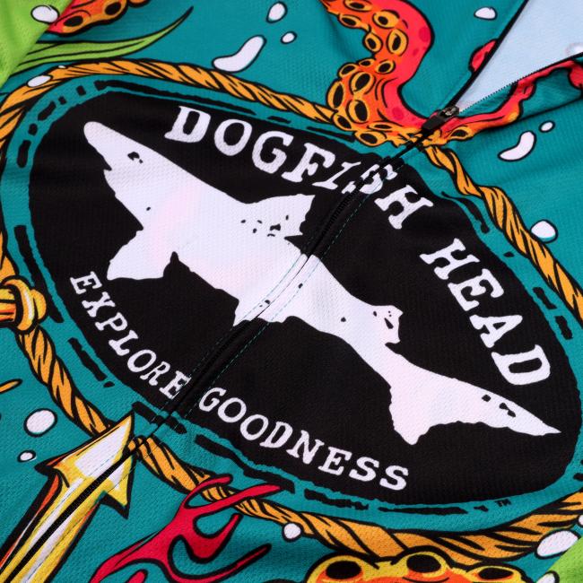 A vibrant short-sleeve cycling jersey with underwater-themed artwork, including tentacles, hops, and sea creatures. The front features the Dogfish Head “Explore Goodness” logo, surrounded by a rope graphic.