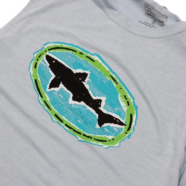 Close-up of the Dogfish Head shark logo on the front of the tank, showing a black shark silhouette inside a turquoise and green oval design.