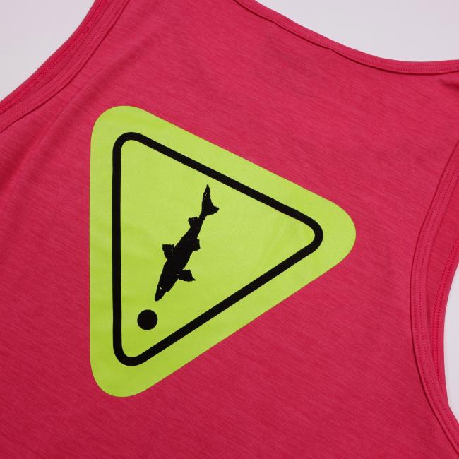 Close-up of the back design showing a neon yellow triangle with a black shark and dot, resembling a playful warning sign graphic.